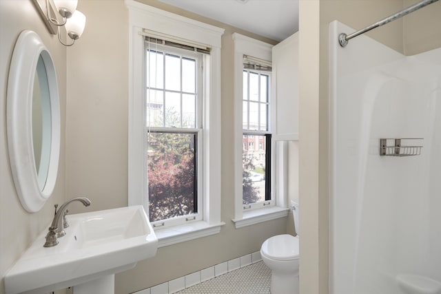 full bathroom with a sink, walk in shower, and toilet