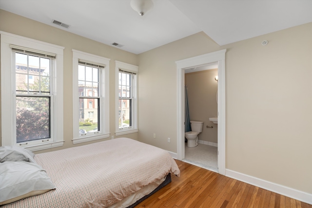 bedroom with visible vents, baseboards, and light wood-type flooring