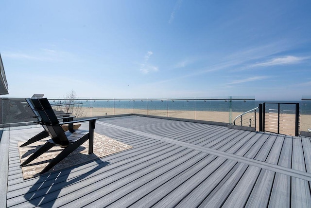 deck with a view of the beach and a water view