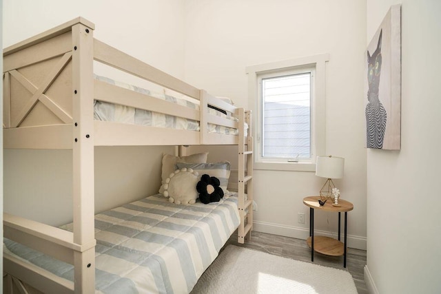 bedroom featuring baseboards and wood finished floors