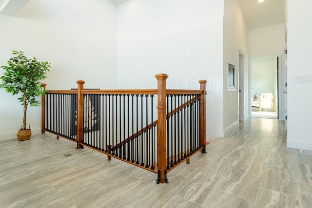 staircase with baseboards and wood finished floors
