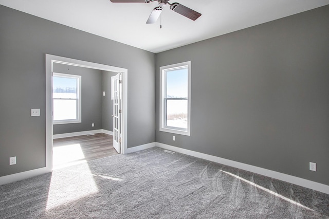 unfurnished room featuring visible vents, ceiling fan, carpet, and baseboards