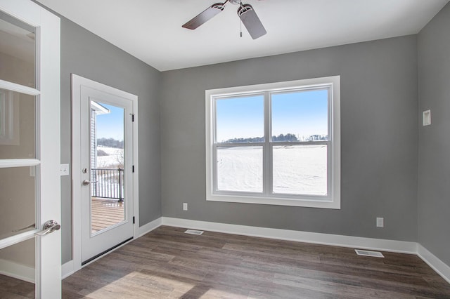 unfurnished room featuring visible vents, ceiling fan, and a healthy amount of sunlight