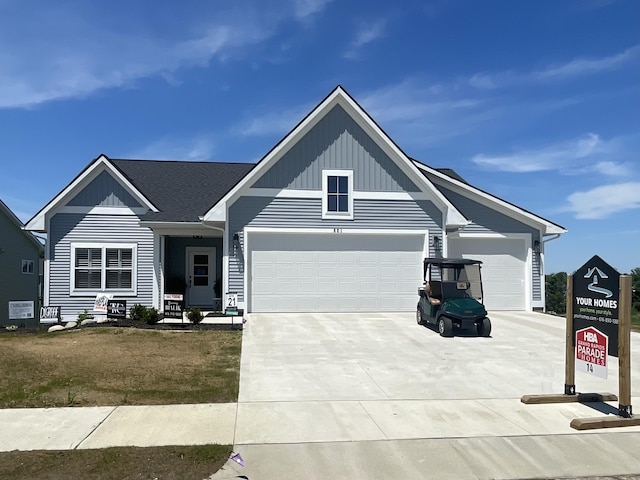 view of front of house with driveway, board and batten siding, and an attached garage