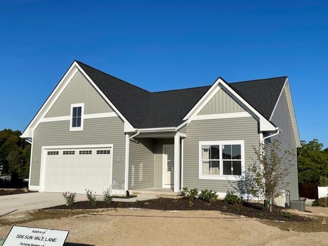 view of front of house featuring concrete driveway, board and batten siding, and a garage