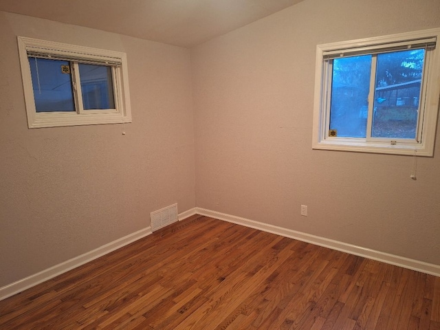 1271 Featherstone Rd, Pontiac, MI 48342 - empty room featuring baseboards, dark wood-style floors, and visible vents