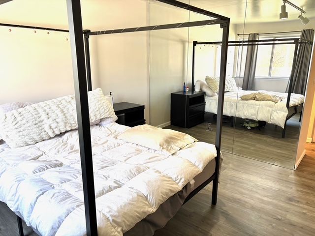 bedroom with baseboards and wood finished floors