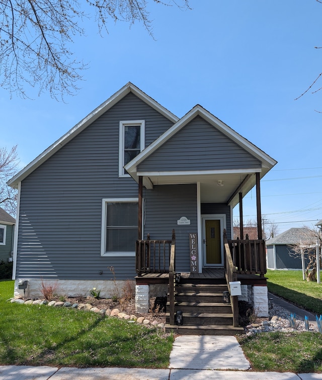bungalow-style home with a porch and a front yard