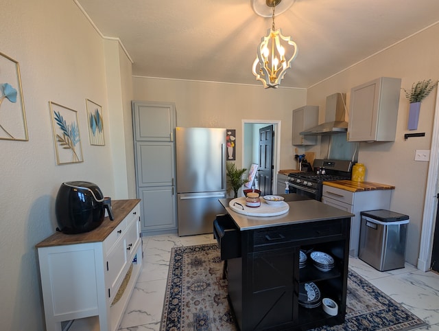 1204 Stanton St, Bay City, MI 48708 - kitchen featuring appliances with stainless steel finishes, wooden counters, wall chimney exhaust hood, and light marble finish flooring