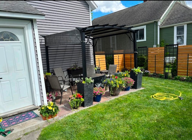 exterior space featuring a lawn, fence, a patio, and a pergola