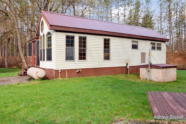 exterior space with a front yard and metal roof
