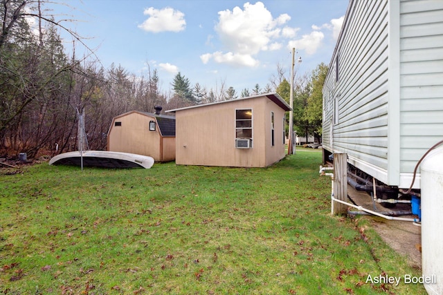 view of yard with a storage unit and an outbuilding