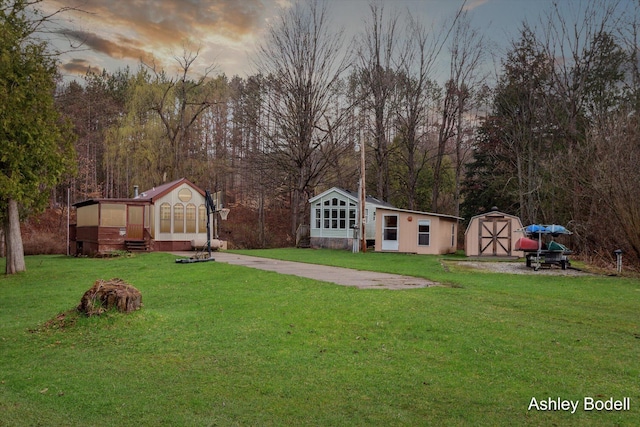 view of yard with a storage unit and an outbuilding