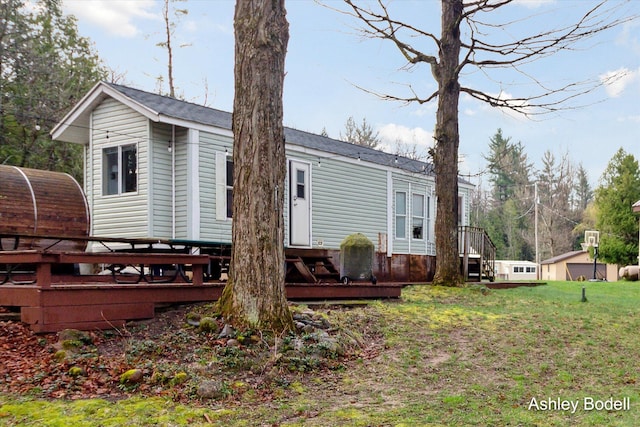 exterior space featuring a lawn and a wooden deck