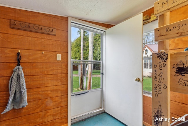 doorway featuring a textured ceiling and plenty of natural light