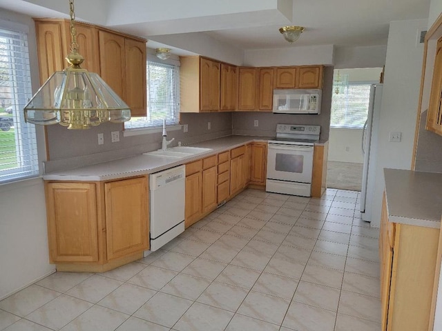 kitchen featuring visible vents, white appliances, light countertops, and a sink