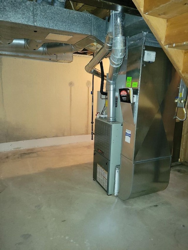 utility room featuring heating unit