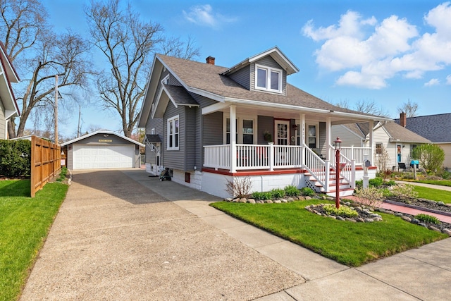 bungalow-style house with a front yard, a garage, an outdoor structure, covered porch, and roof with shingles