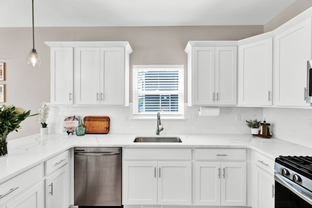 kitchen with a sink, tasteful backsplash, white cabinetry, and appliances with stainless steel finishes