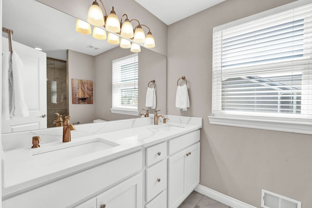 bathroom with a sink, baseboards, marble finish floor, and visible vents