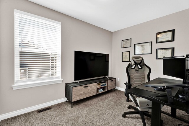 carpeted office space featuring visible vents and baseboards