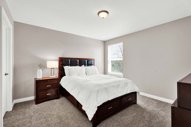 bedroom featuring baseboards and light carpet