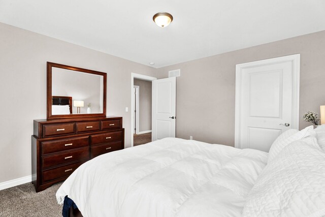 carpeted bedroom with baseboards and visible vents