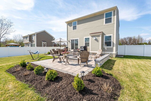 back of house with a lawn, a patio area, and a fenced backyard