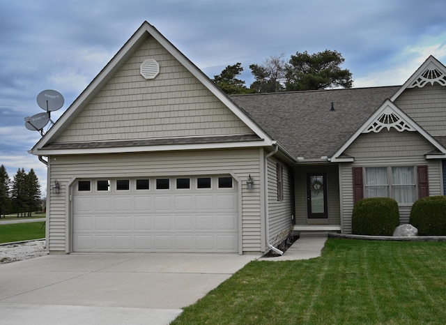 view of front of house with concrete driveway, a front yard, a shingled roof, and a garage