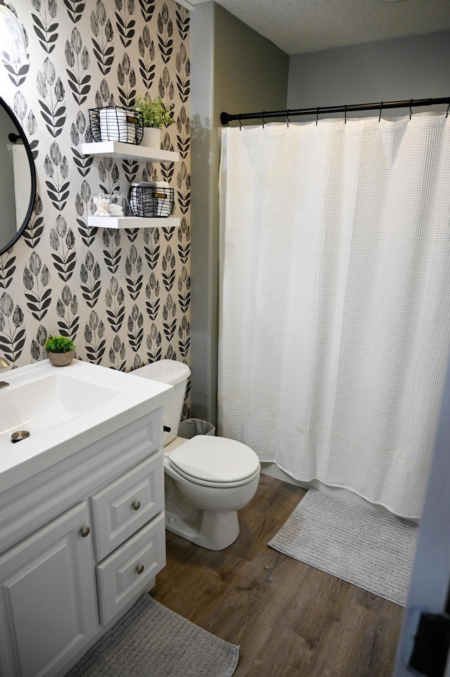 full bathroom with wood finished floors, toilet, a shower with curtain, and vanity