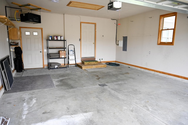 garage with electric panel, a garage door opener, and baseboards