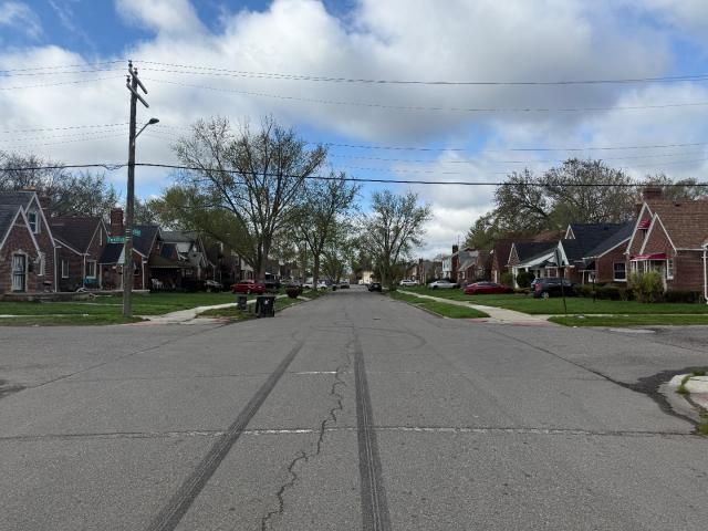view of road with street lighting, curbs, sidewalks, and a residential view