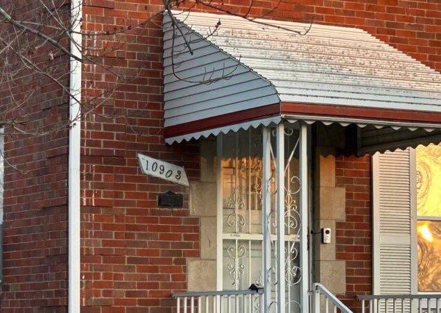 view of exterior entry with brick siding