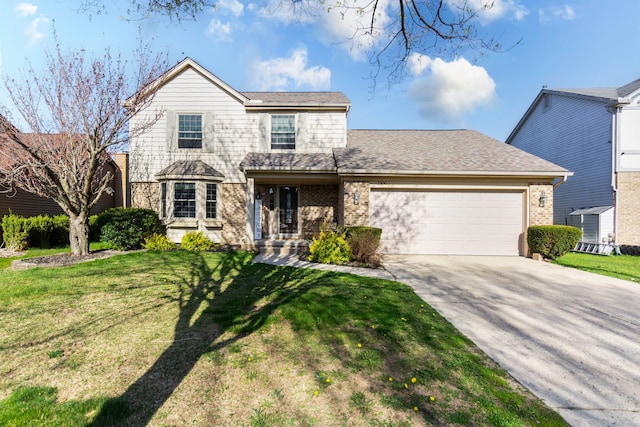 traditional-style home with brick siding, a garage, a front lawn, and driveway