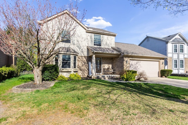 traditional home with a garage, driveway, brick siding, and a front yard