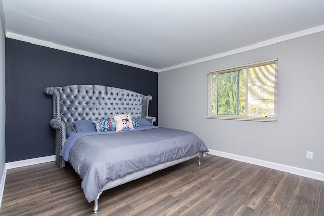 bedroom featuring crown molding, baseboards, and wood finished floors