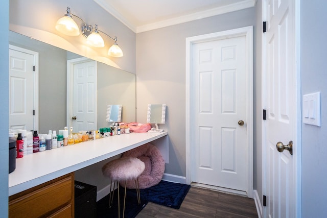 bathroom with vanity, ornamental molding, baseboards, and wood finished floors