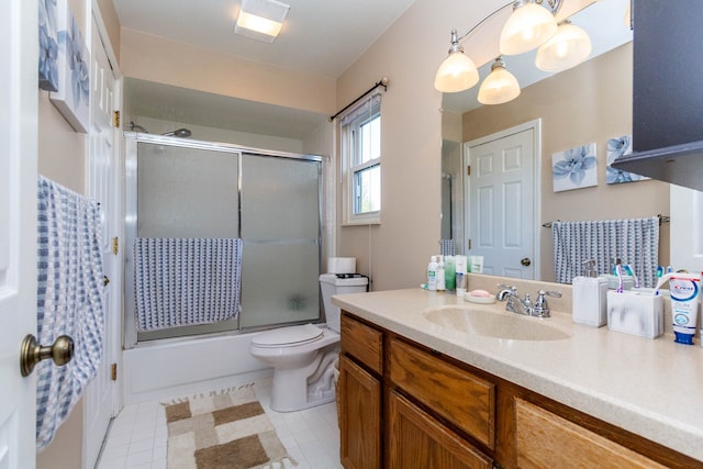 full bathroom featuring vanity, tile patterned flooring, bath / shower combo with glass door, and toilet
