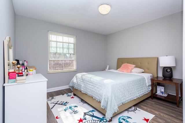 bedroom featuring baseboards and wood finished floors