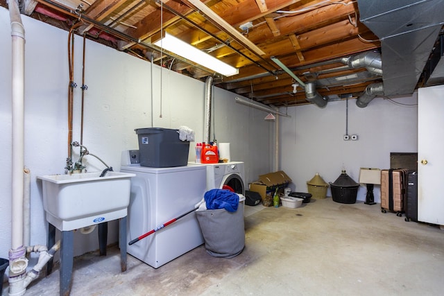 unfinished below grade area with a sink and washing machine and dryer