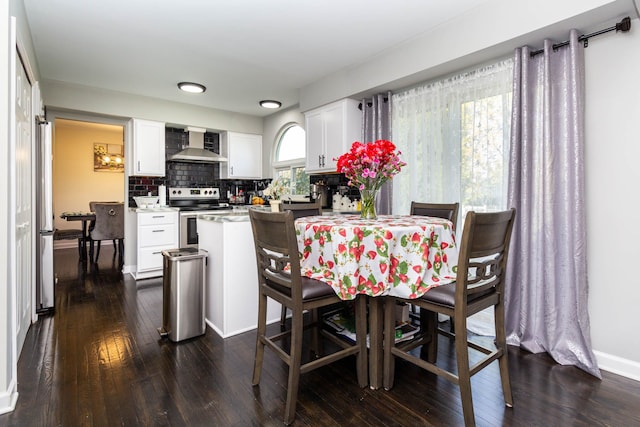 dining area with baseboards and dark wood-style flooring
