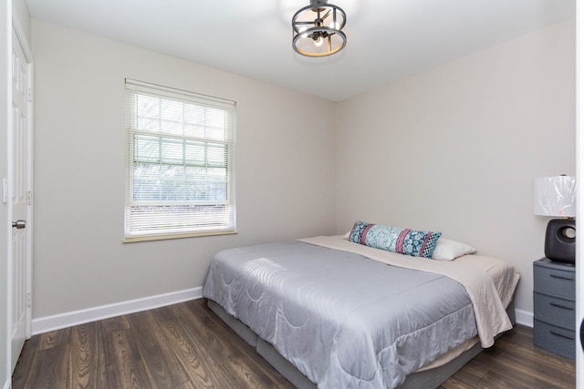 bedroom featuring baseboards and wood finished floors