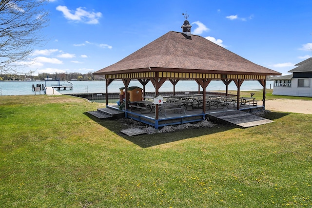 dock area featuring a yard, a water view, and a gazebo