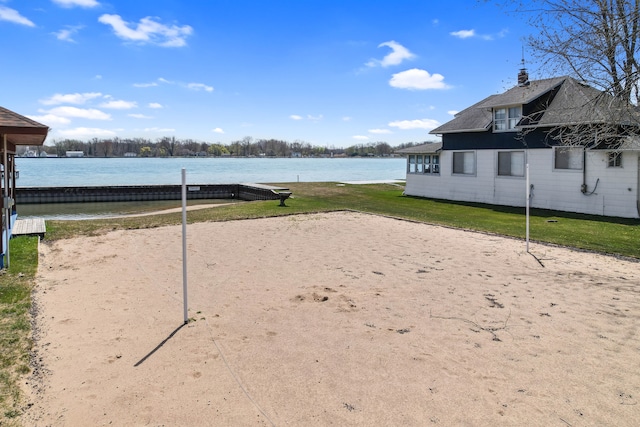 view of community with a water view and a yard