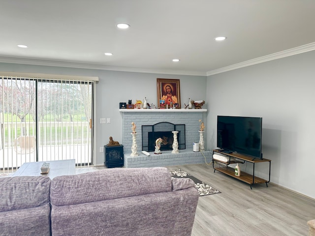 living room with recessed lighting, a fireplace, crown molding, baseboards, and wood finished floors