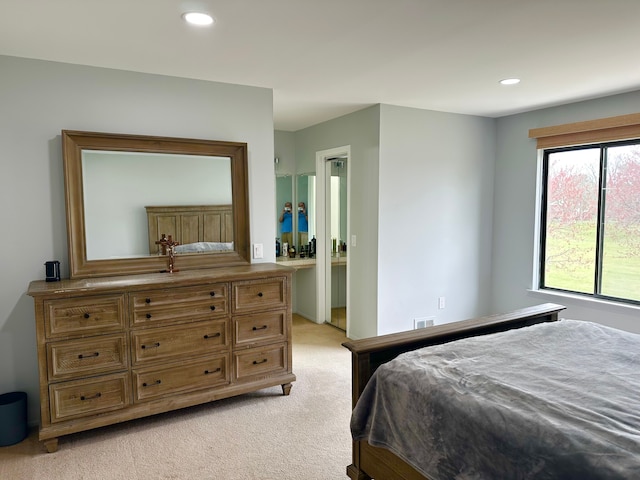 bedroom with visible vents, recessed lighting, and light colored carpet