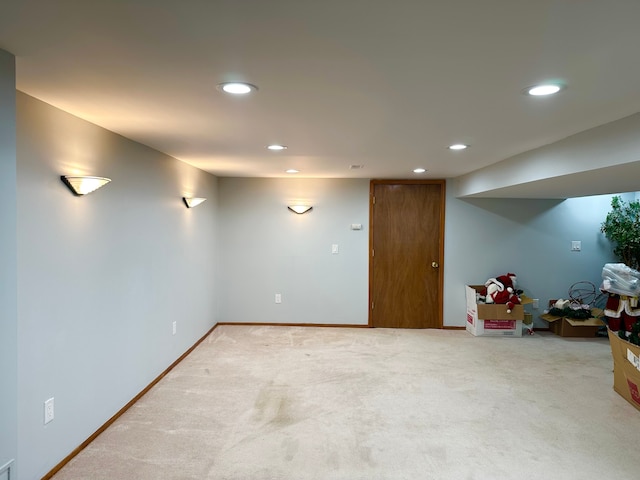 finished below grade area with recessed lighting, light carpet, and baseboards
