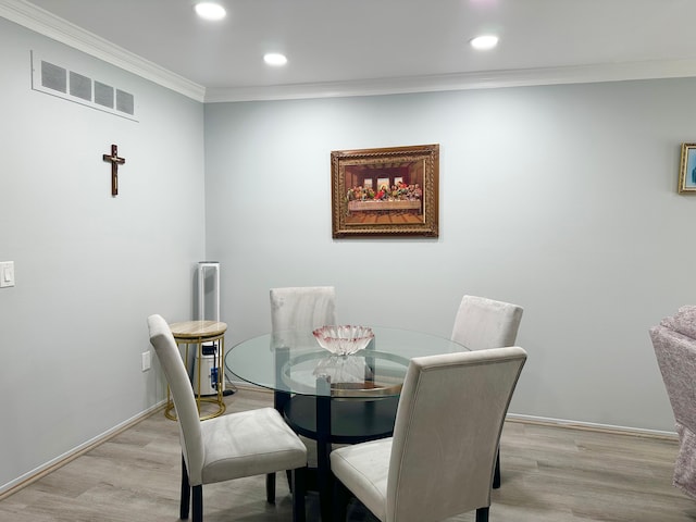 dining space with ornamental molding, recessed lighting, visible vents, and light wood-style flooring