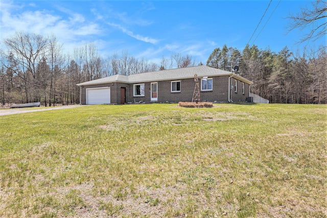 single story home with driveway, a front yard, and a garage