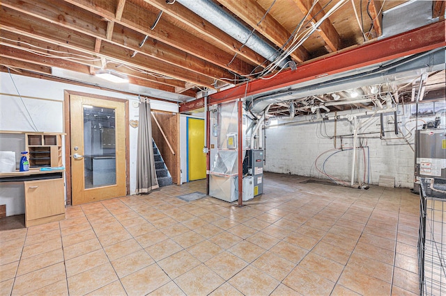 unfinished basement featuring stairs, heating unit, gas water heater, and tile patterned flooring